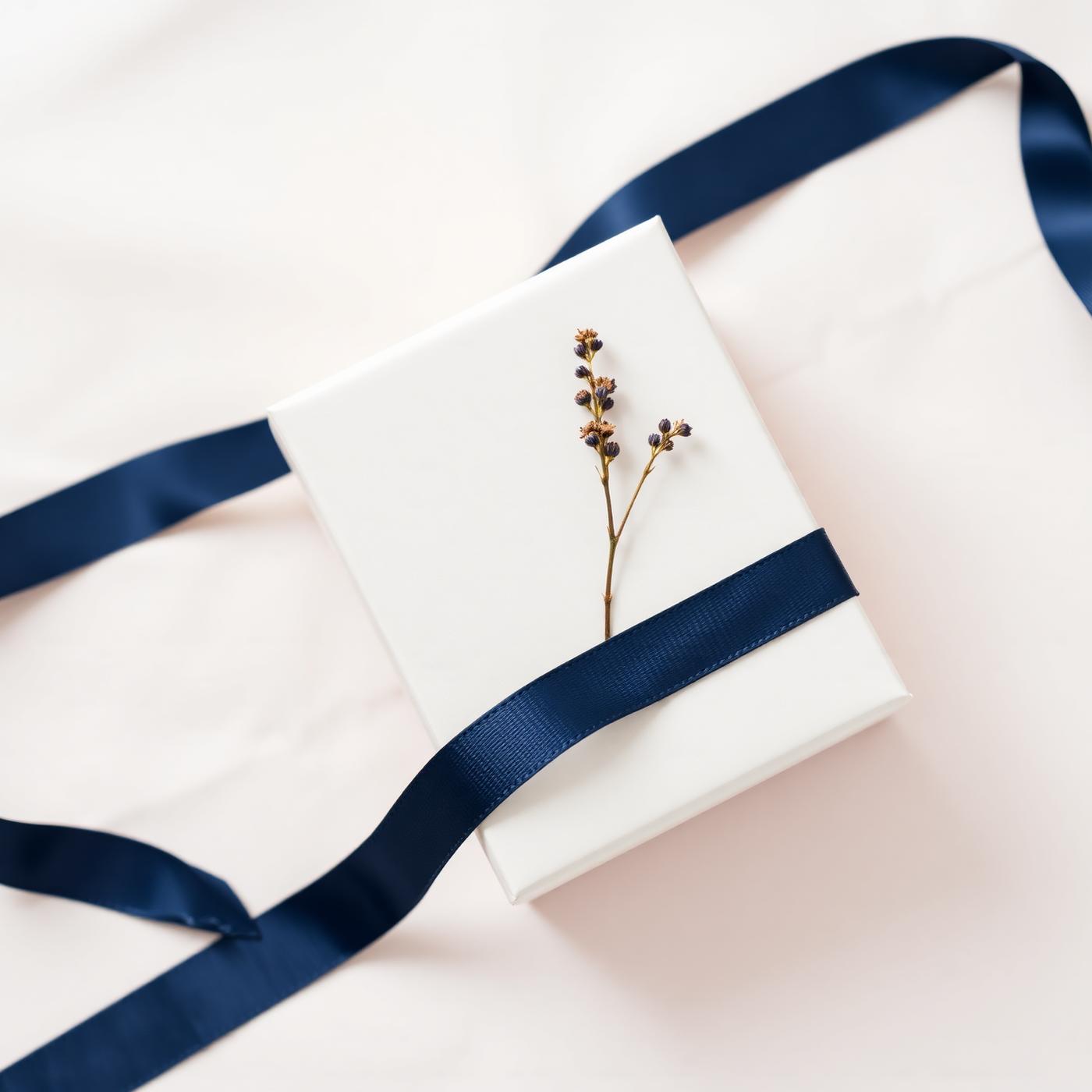 A cream gift box with navy ribbon
